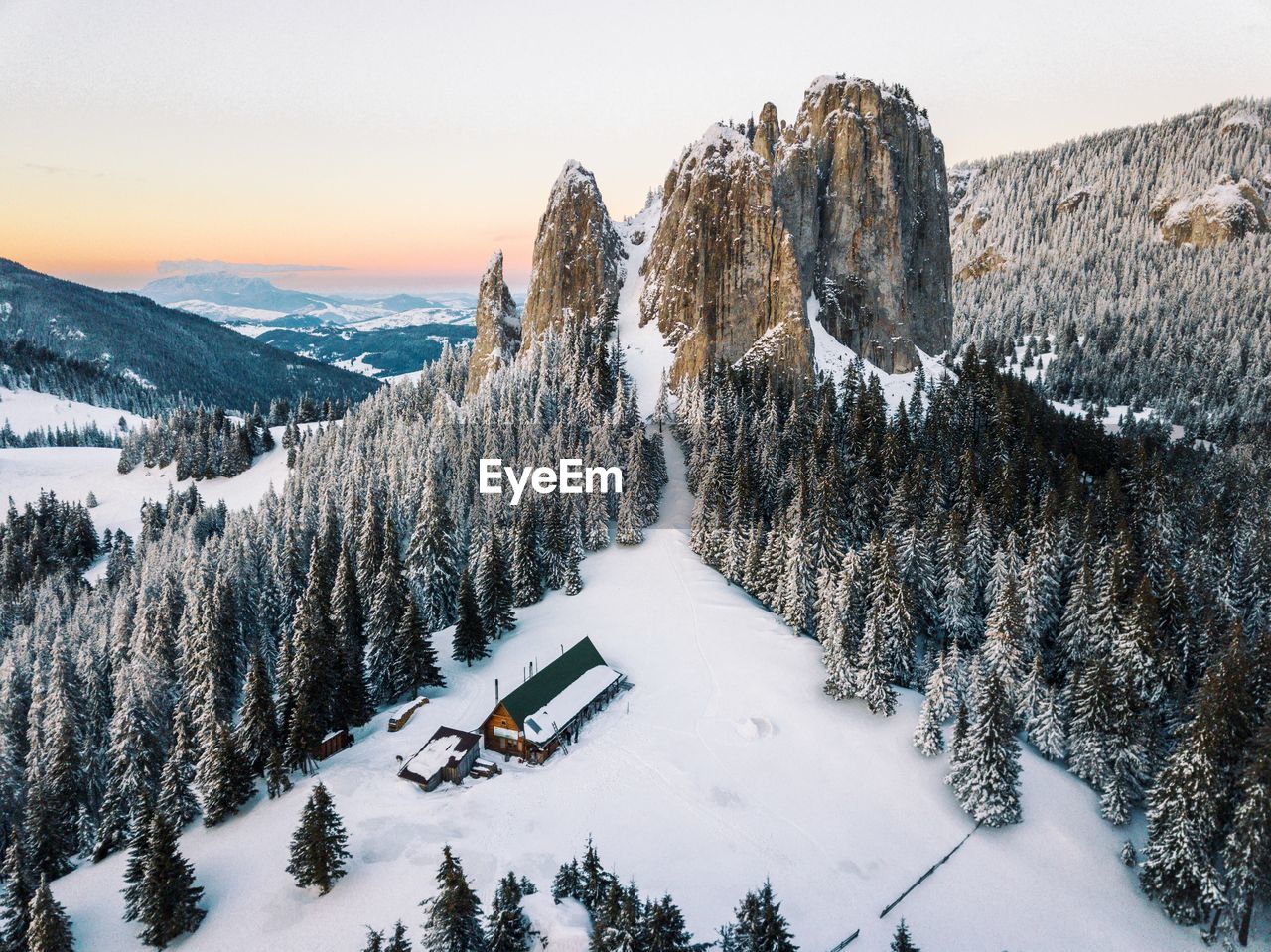 PANORAMIC VIEW OF TREES ON SNOW COVERED MOUNTAINS