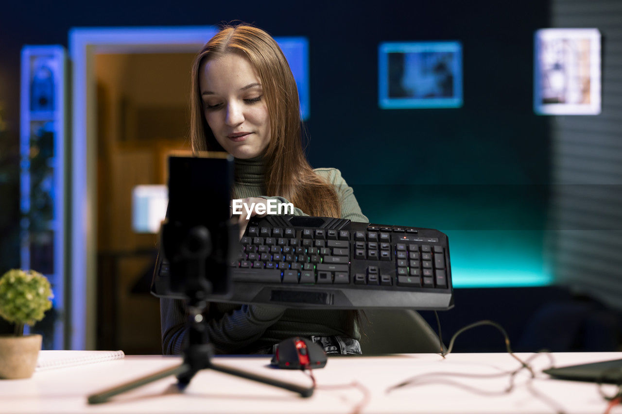 portrait of young woman using laptop on table
