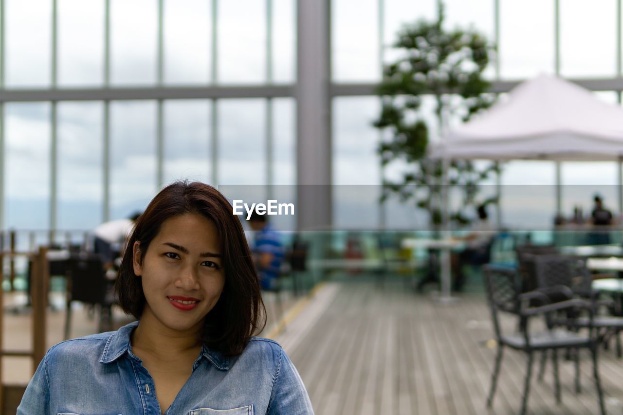 Portrait of smiling young woman in cafe