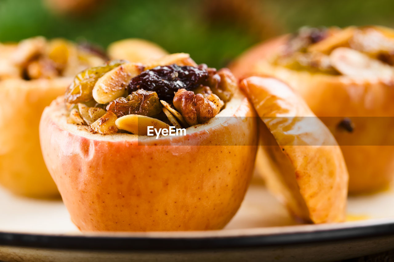 Close-up of apple with dry fruit on table