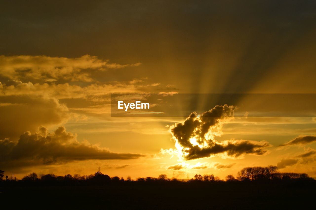 SCENIC VIEW OF SILHOUETTE LANDSCAPE AGAINST DRAMATIC SKY