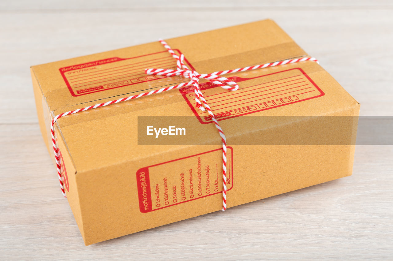 Brown parcel box of thailand on a wooden table