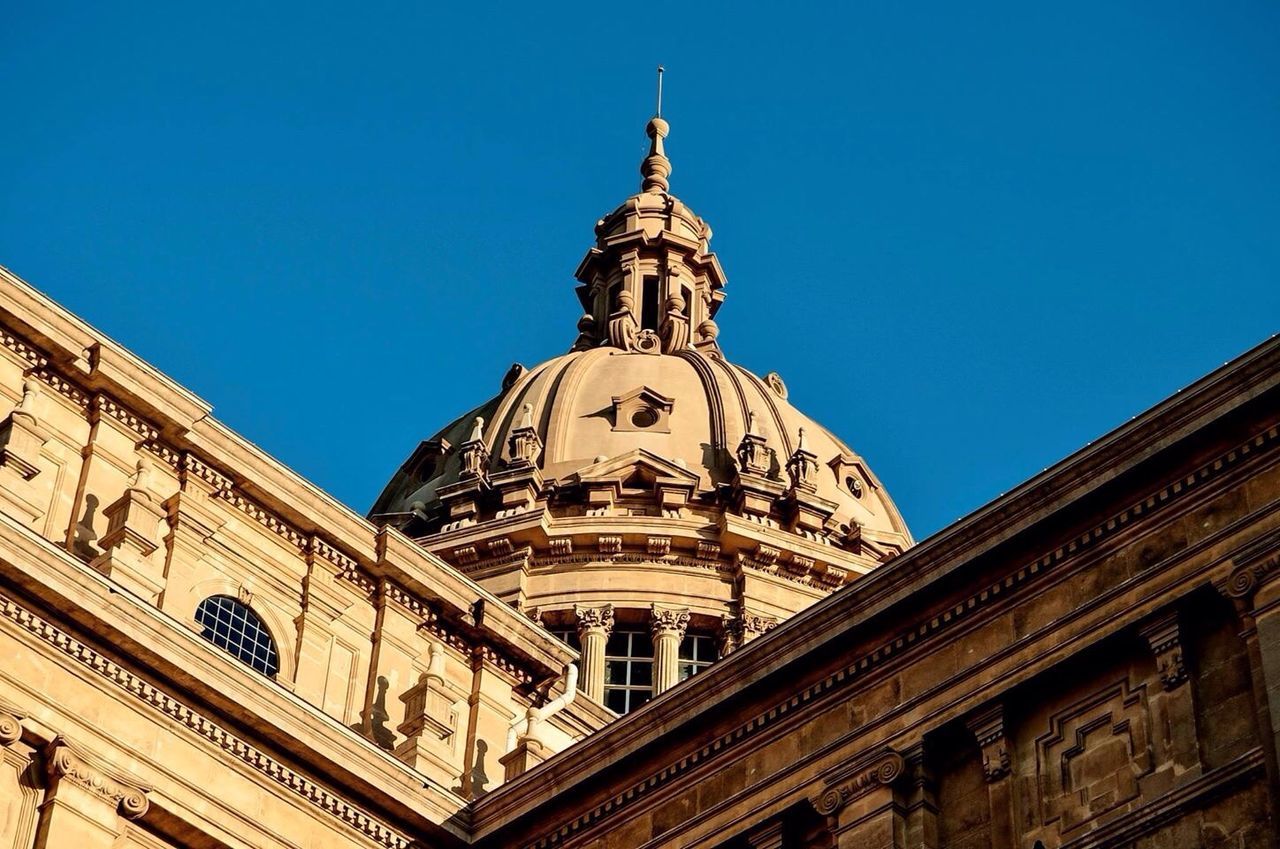 Low angle view of historic building against clear blue sky