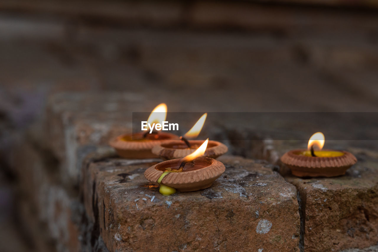 Close-up of illuminated diyas 