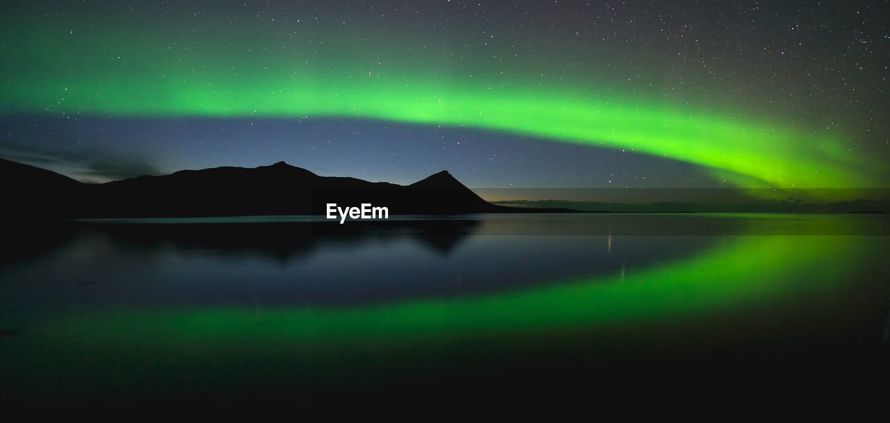 Scenic view of lake against sky at night