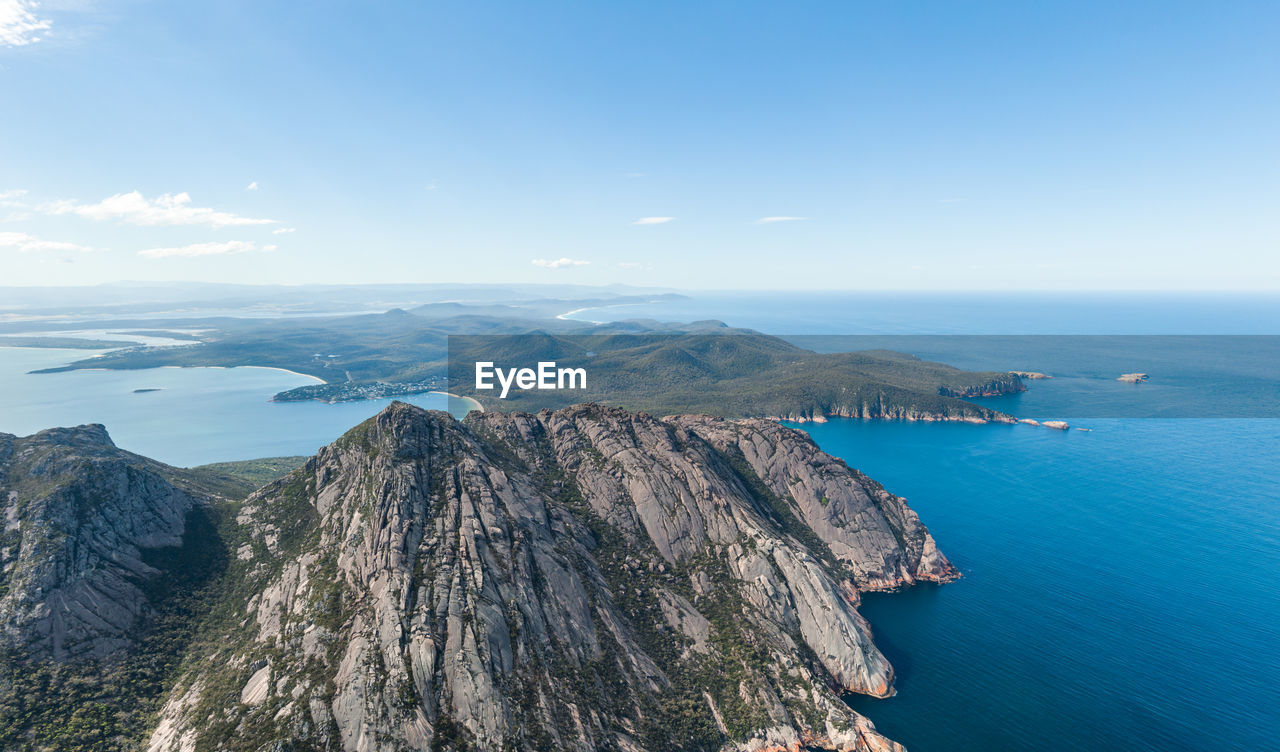 Aerial drone view of coles bay and freycinet national park. hazards mountain range in the foreground