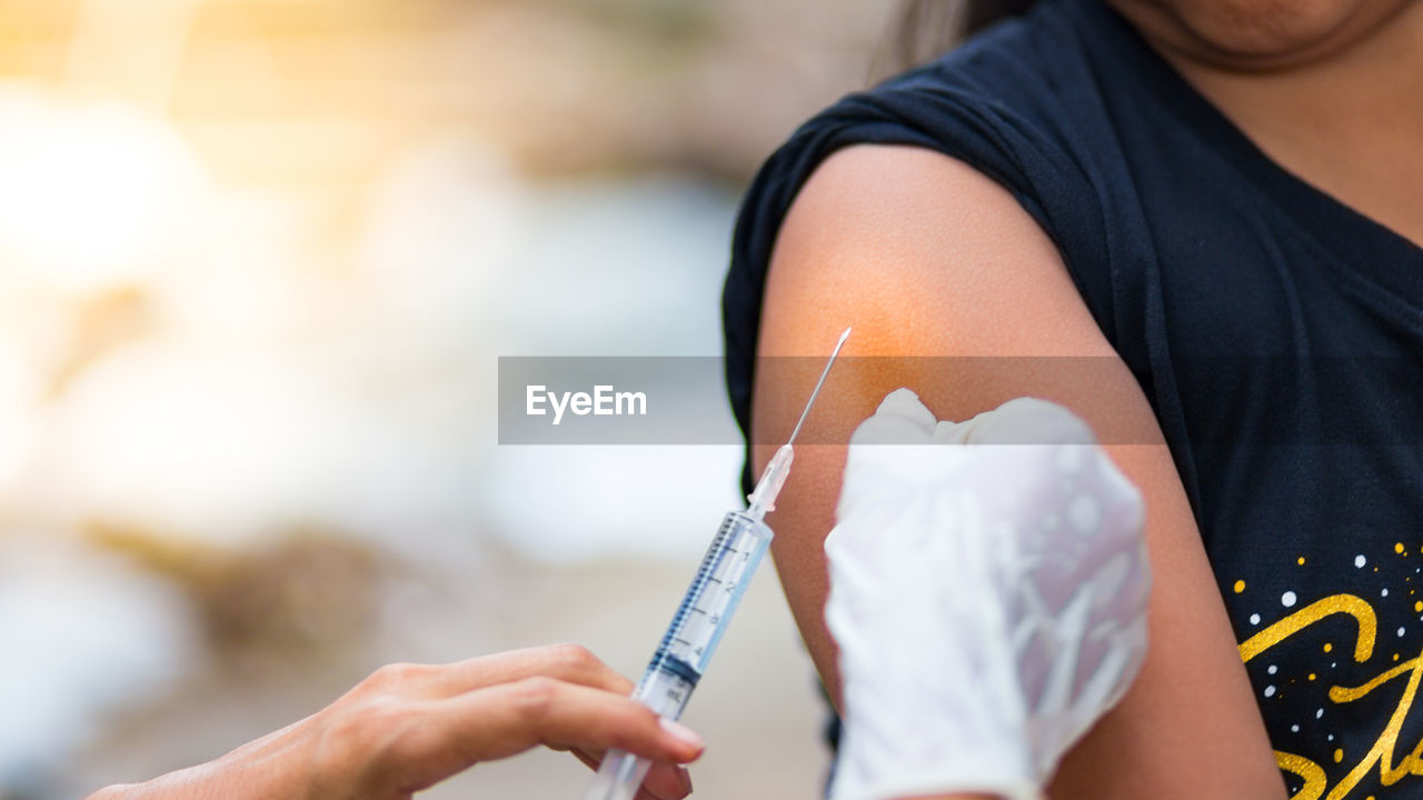 Close-up of doctor giving injection to patient