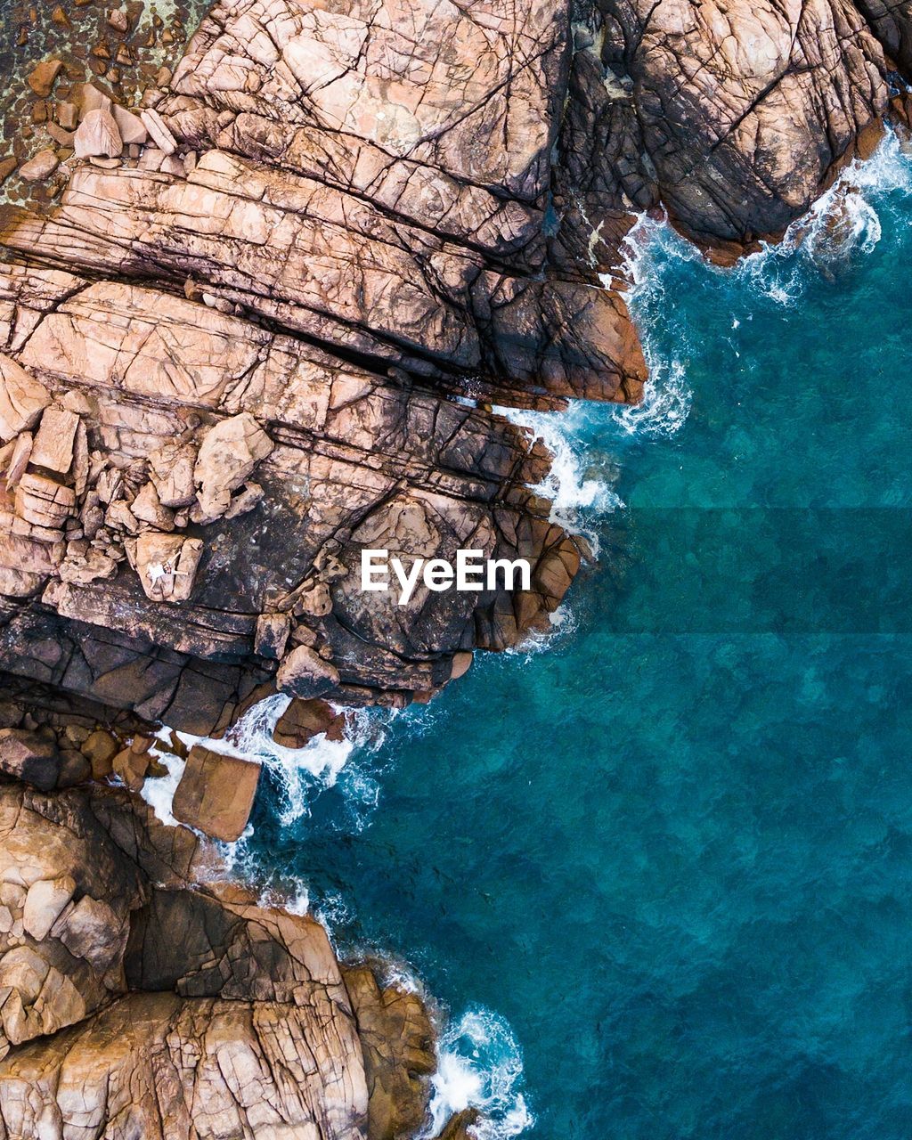 High angle view of rocks by sea