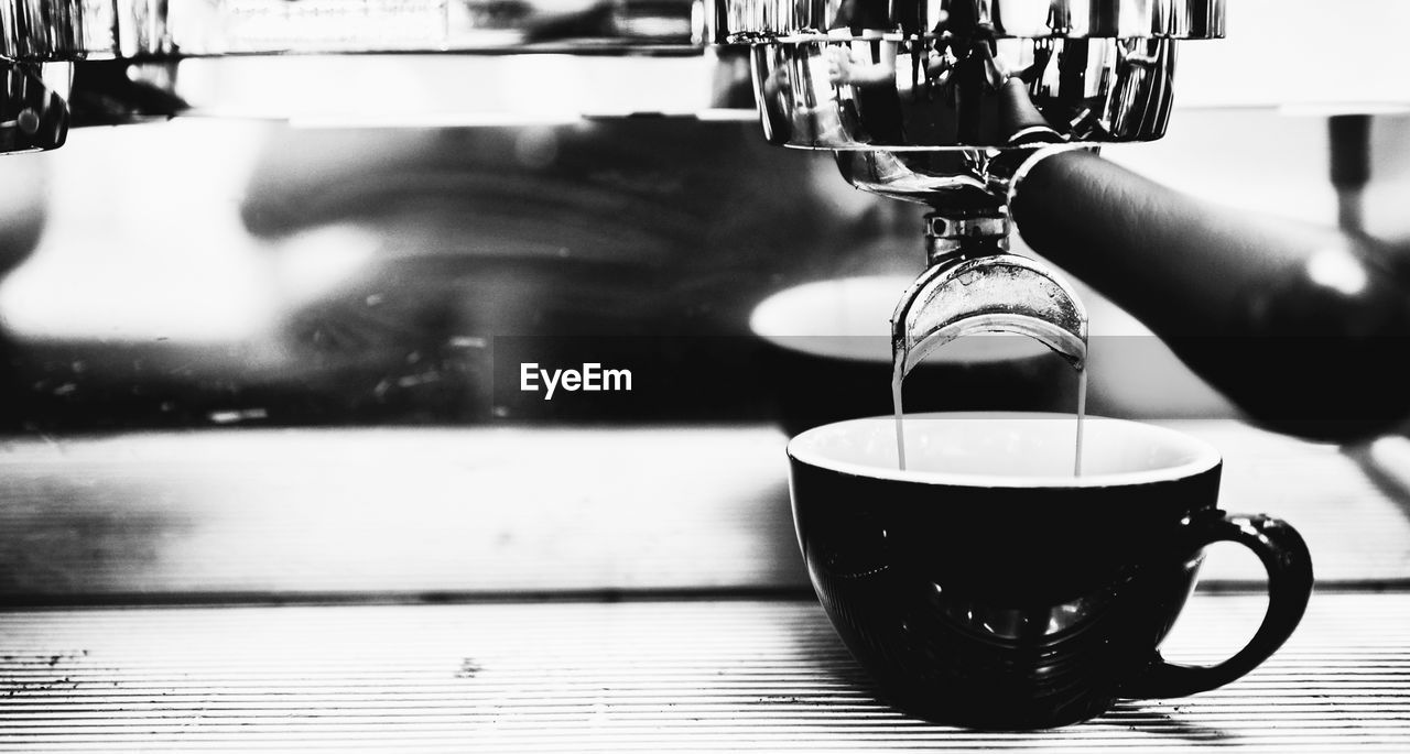 CLOSE-UP OF COFFEE CUP IN GLASS