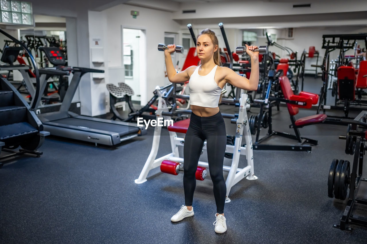 side view of man exercising in gym