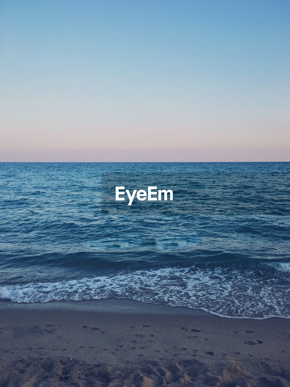 Scenic view of sea against blue sky