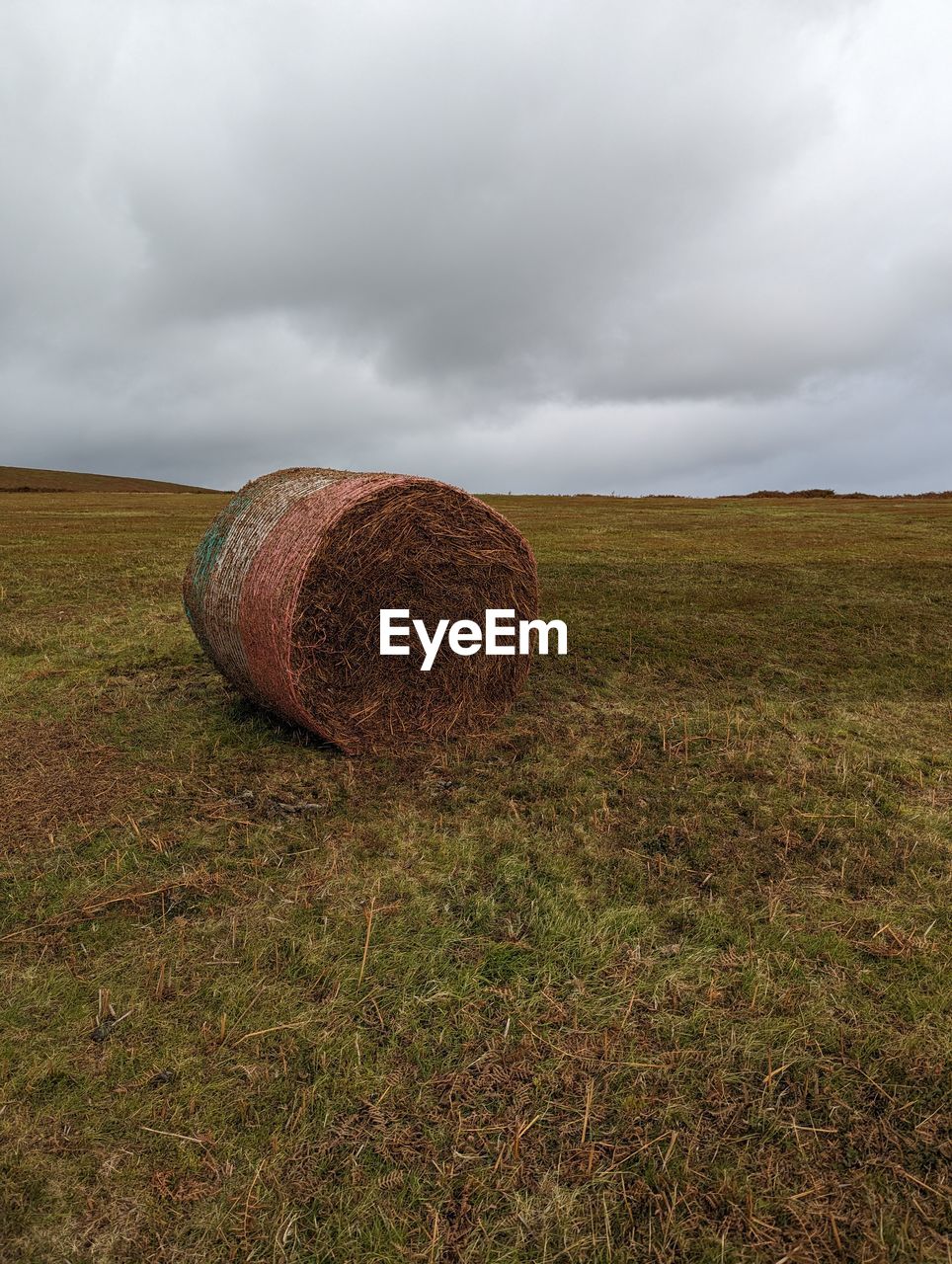 Hay bales on field against sky