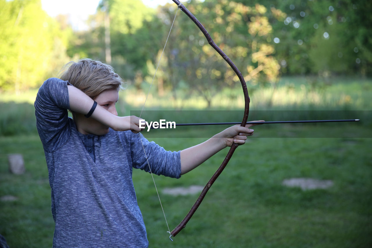 Boy holding boy and arrow