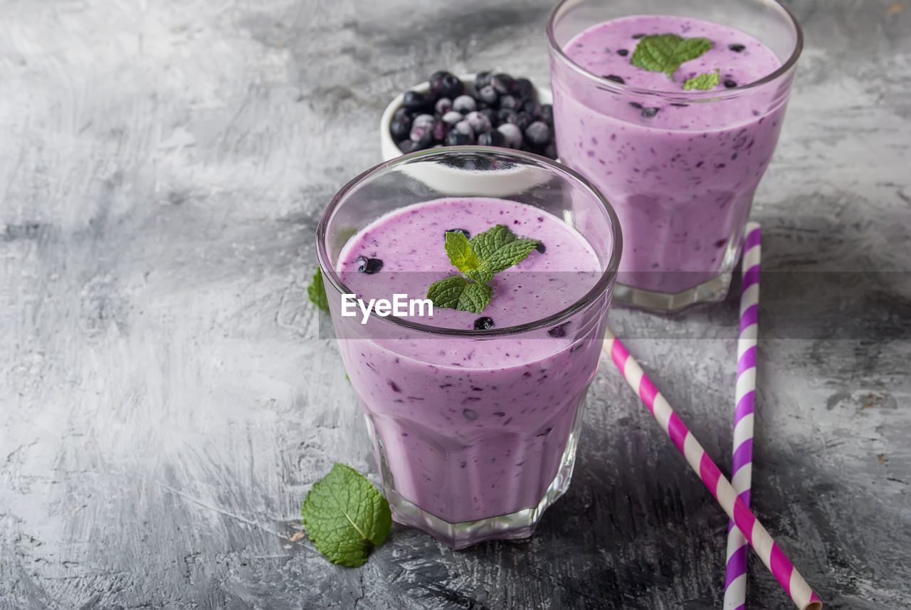 High angle view of smoothie in drinking glasses on table