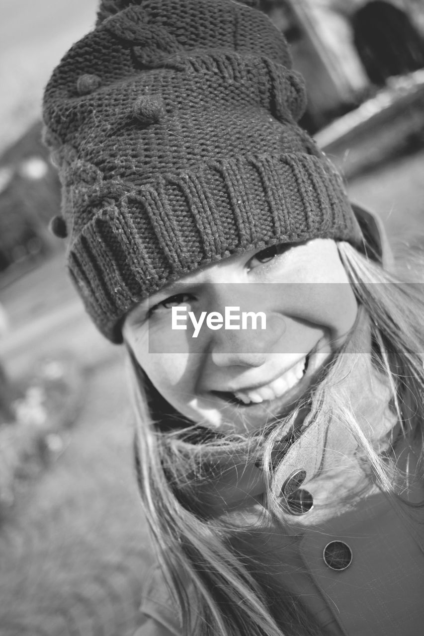 Close-up of young woman smiling young woman wearing knit hat