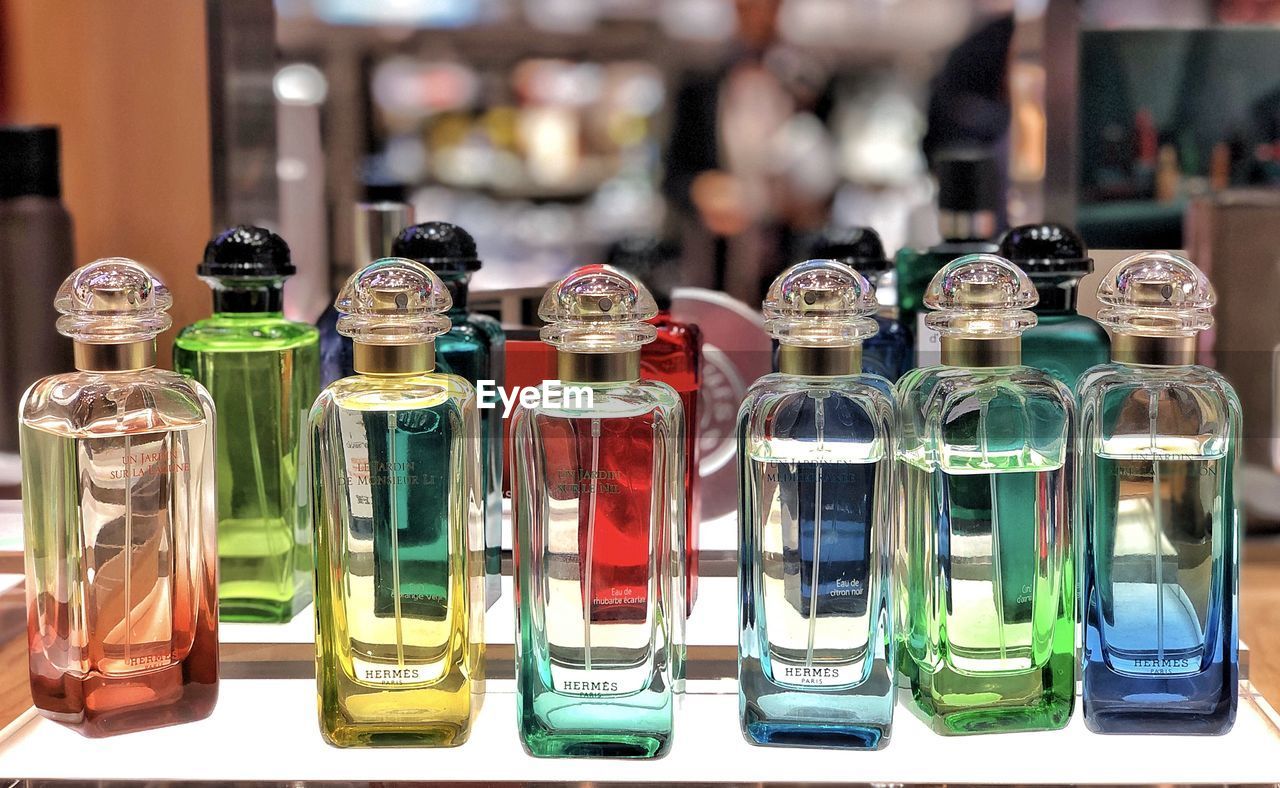 CLOSE-UP OF GLASS BOTTLES ON TABLE AT MARKET STALL