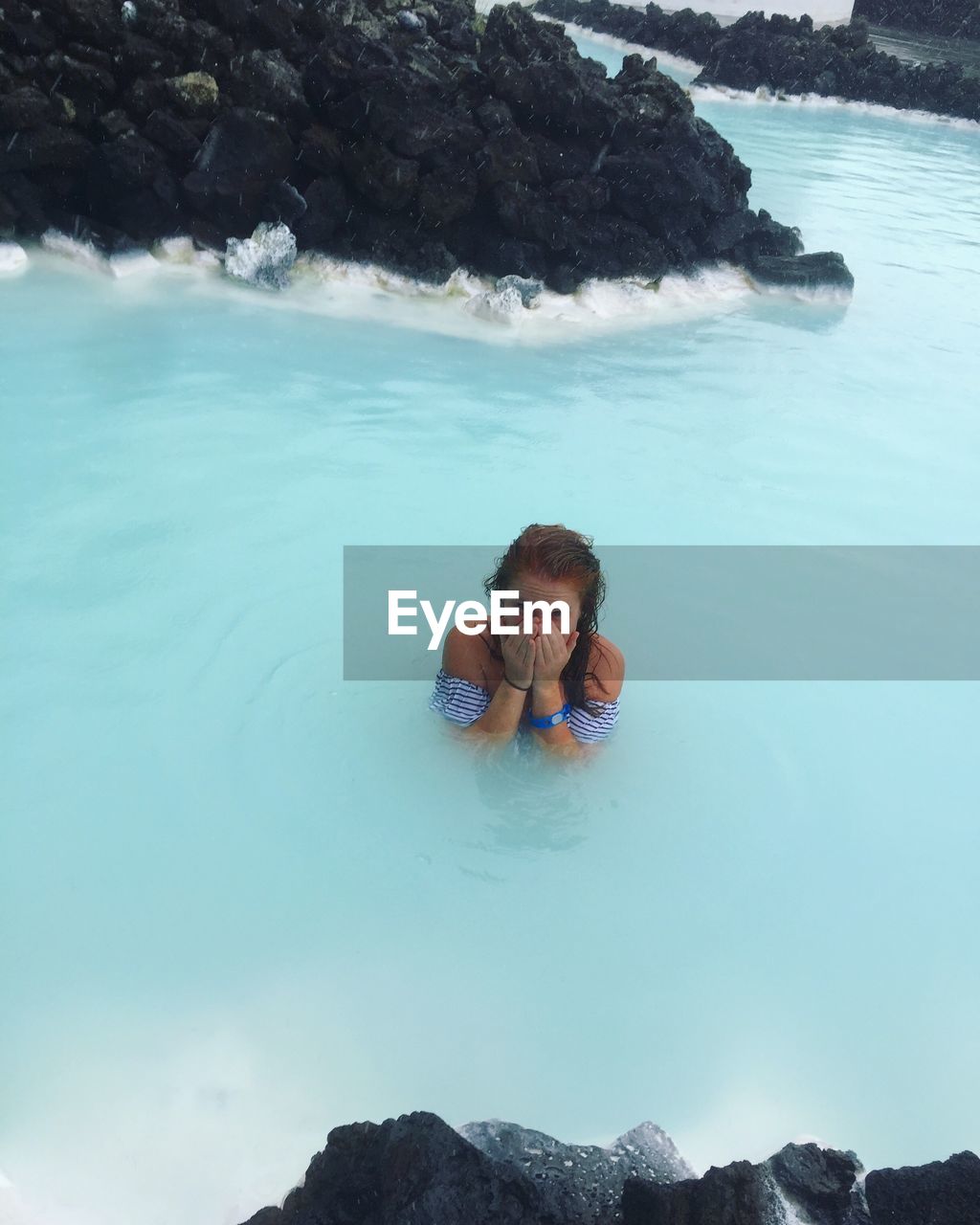 High angle view of young woman in water