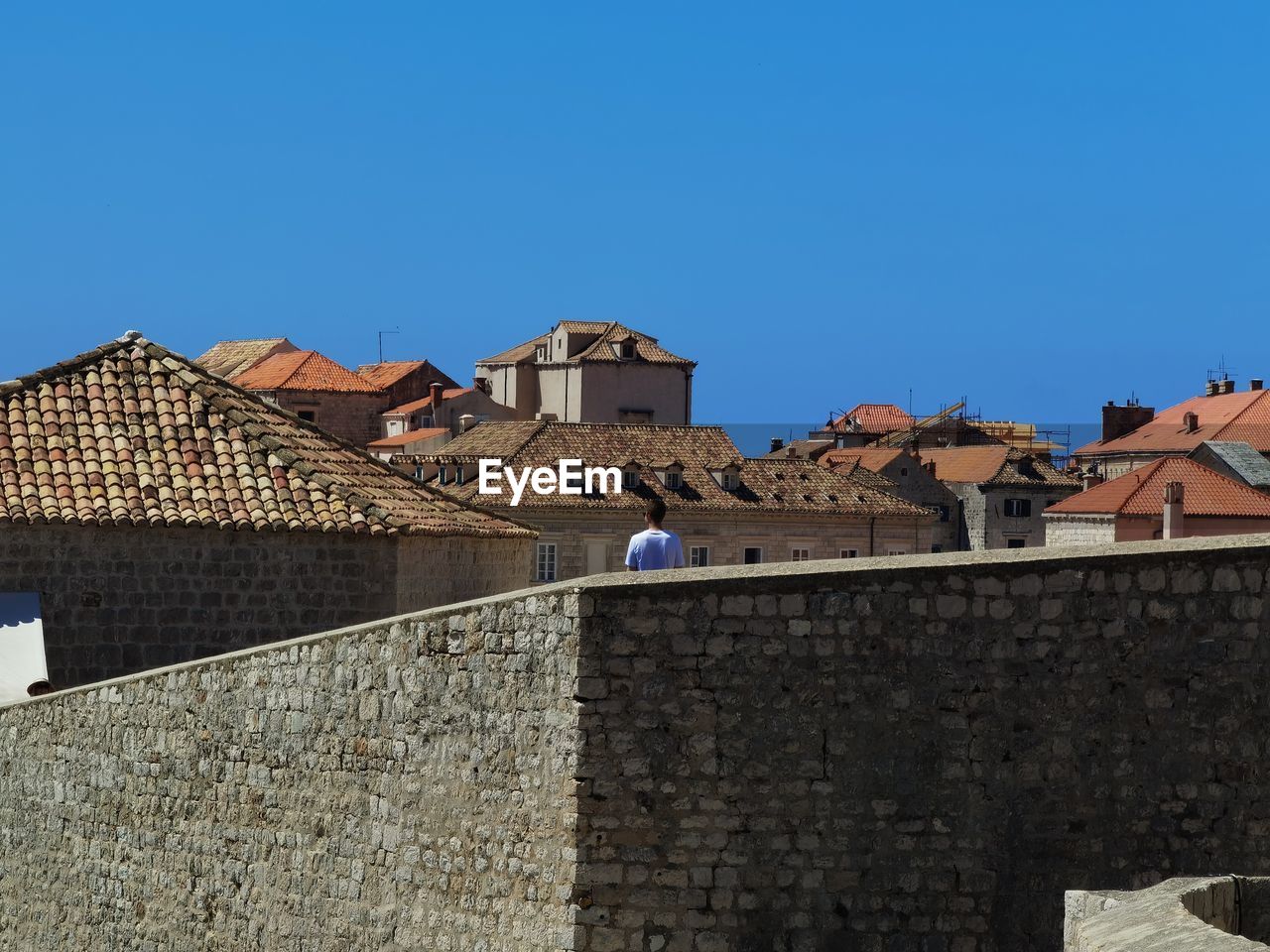 buildings in town against clear blue sky