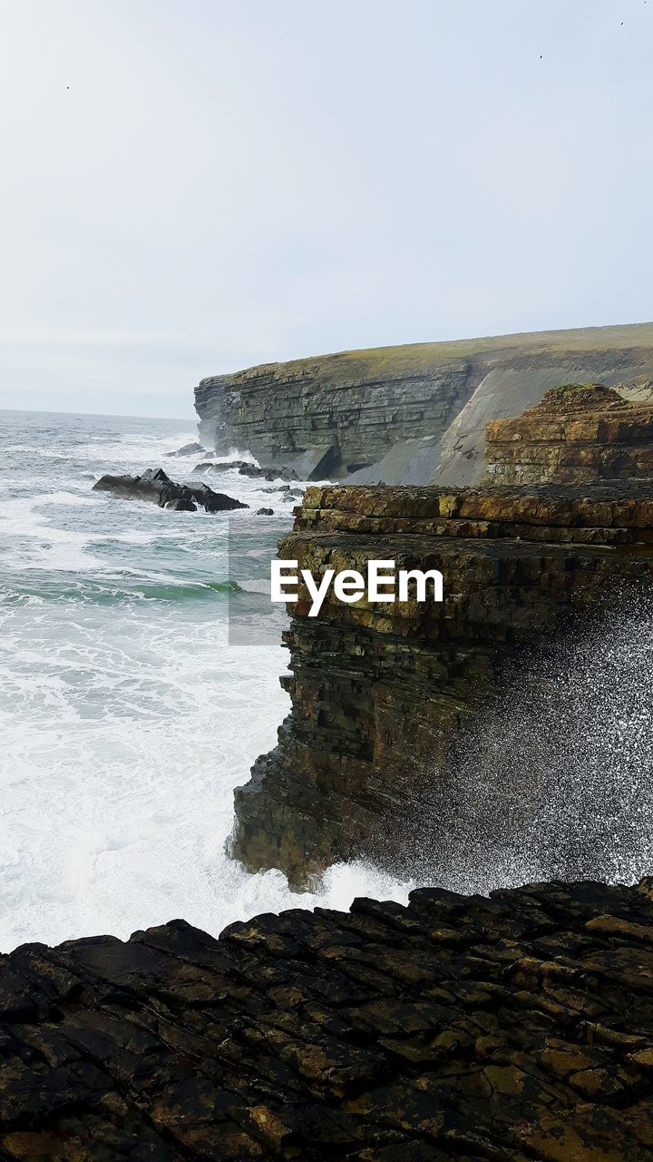 ROCK FORMATION BY SEA AGAINST SKY