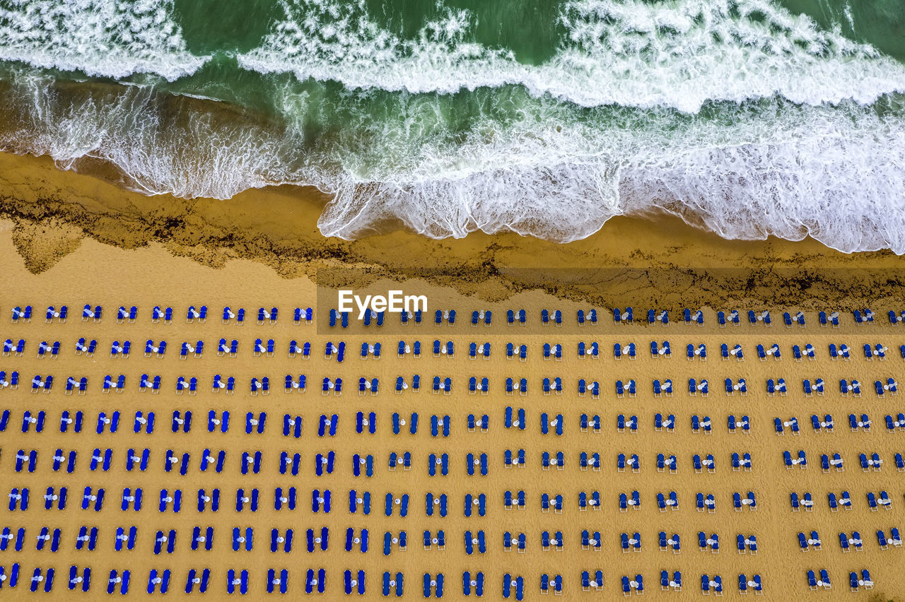 High angle view of lounge chairs at beach