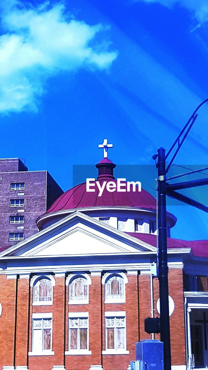 LOW ANGLE VIEW OF BUILDINGS AGAINST BLUE SKY AND CLOUDS