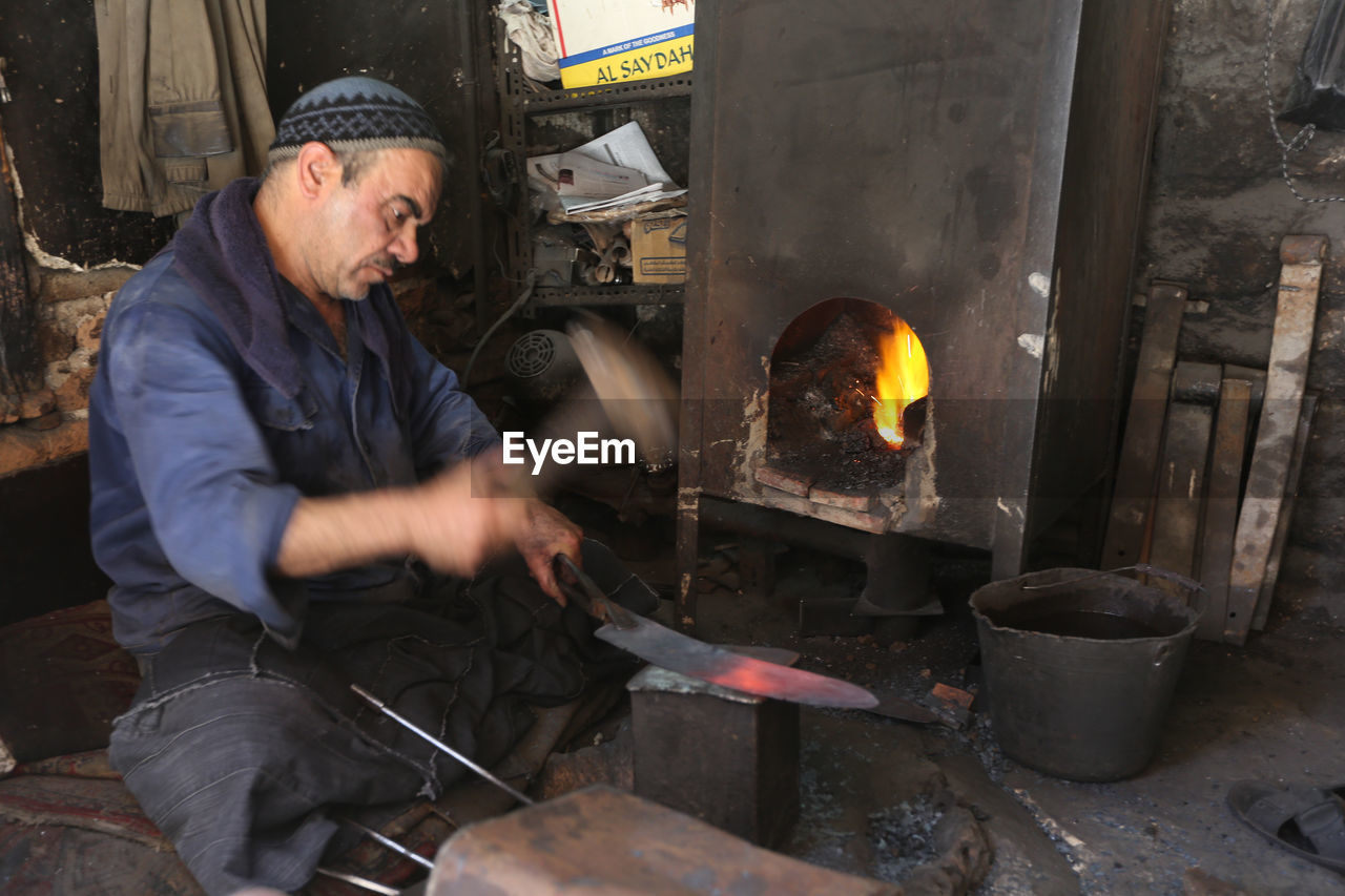 MAN WORKING IN COOKING