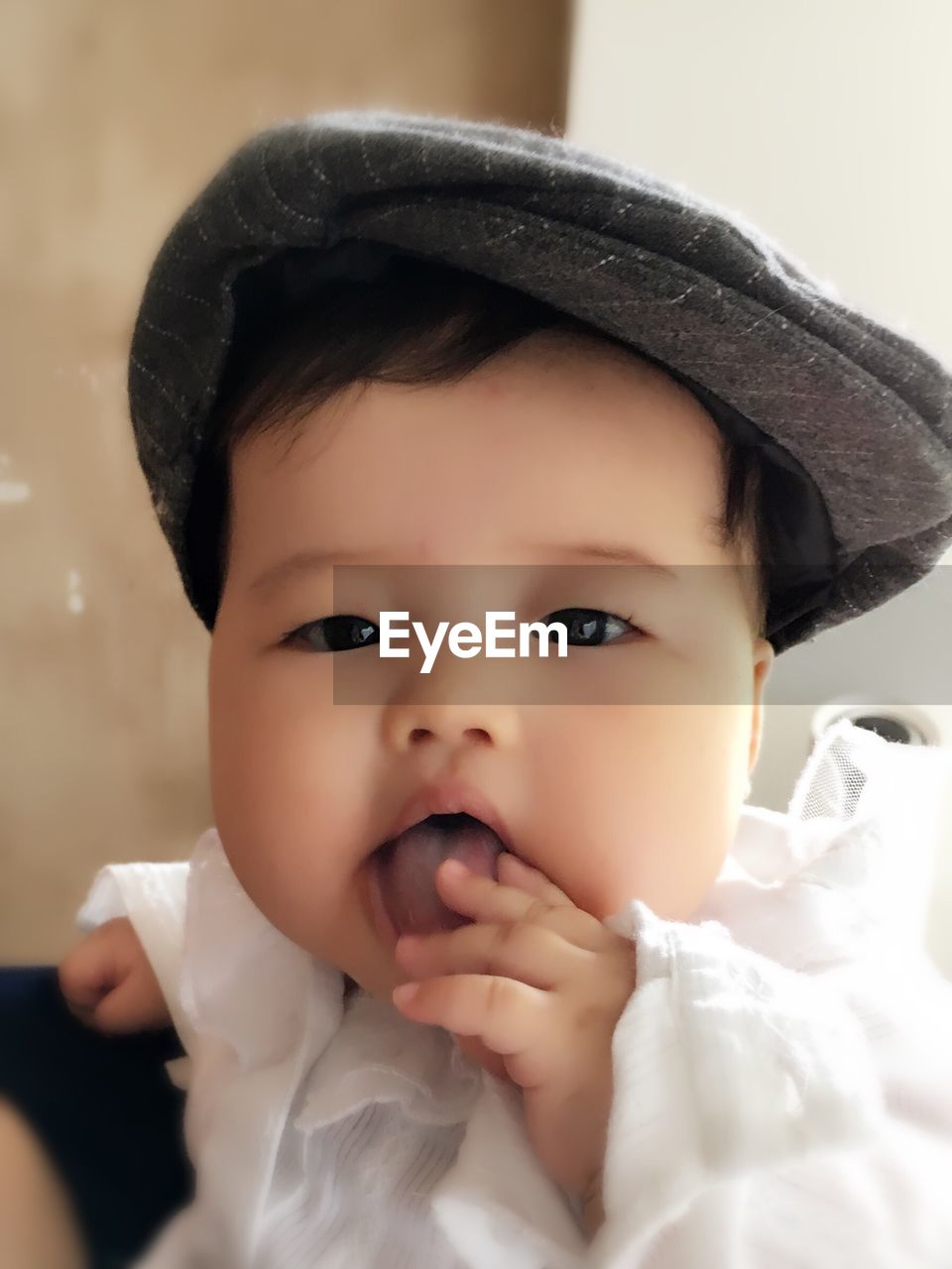 Portrait of cute baby girl on bed at home