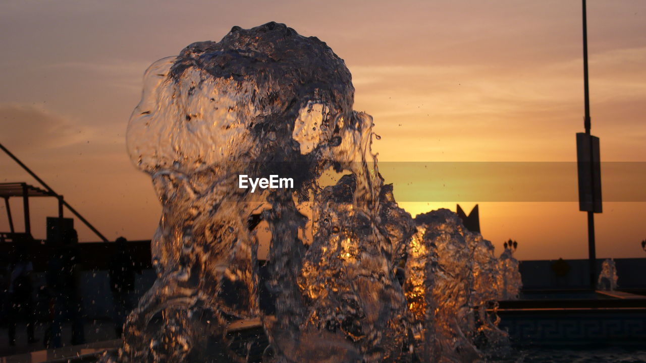 CLOSE-UP OF FOUNTAIN AT SUNSET