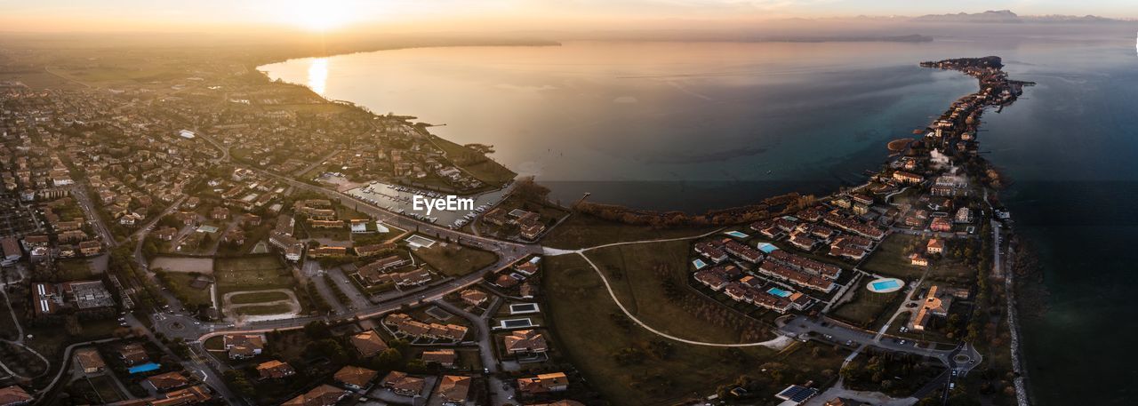 High angle view of buildings in city during sunset