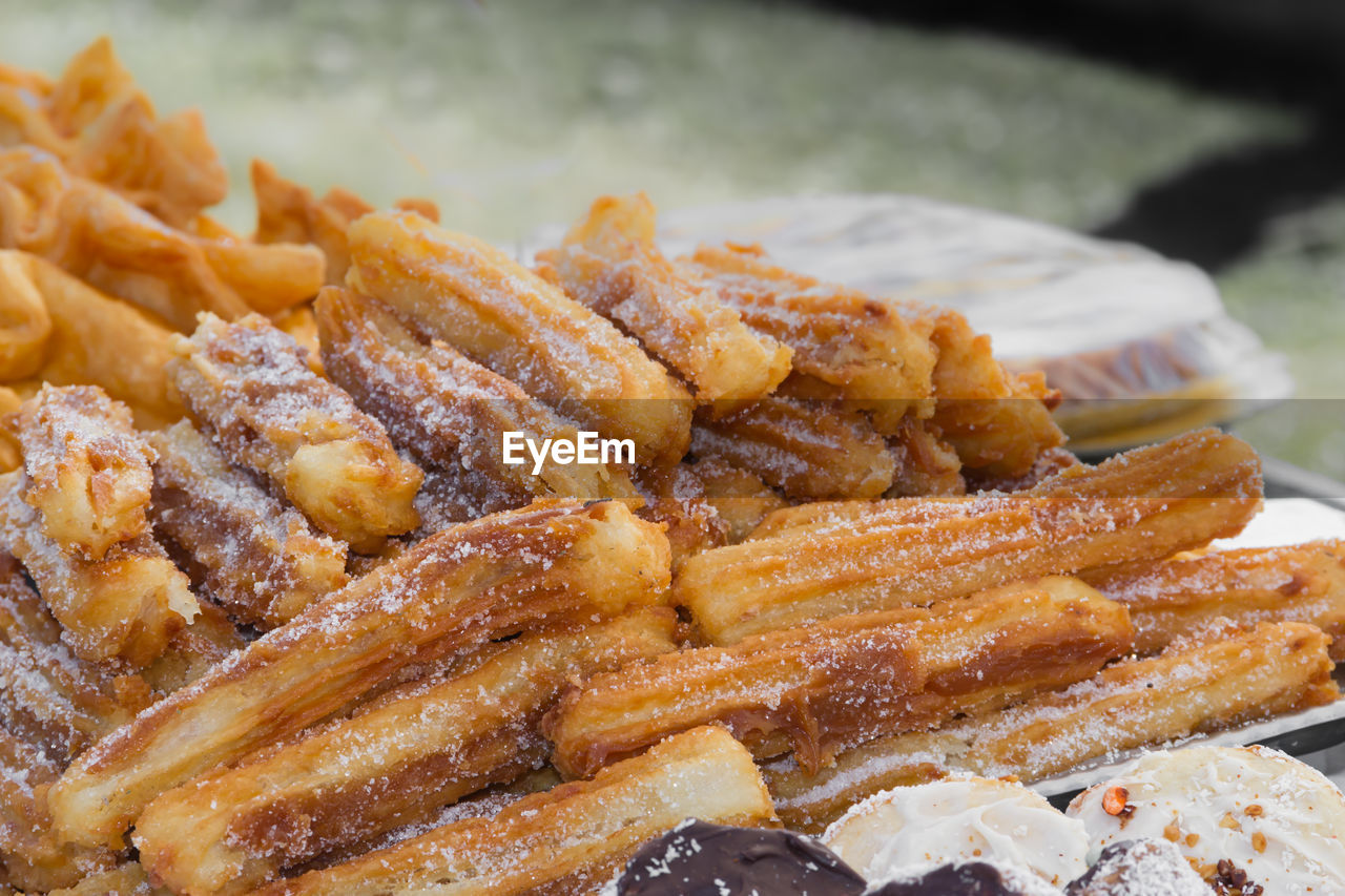 Sweet churros and alfajores for sale at the street fair