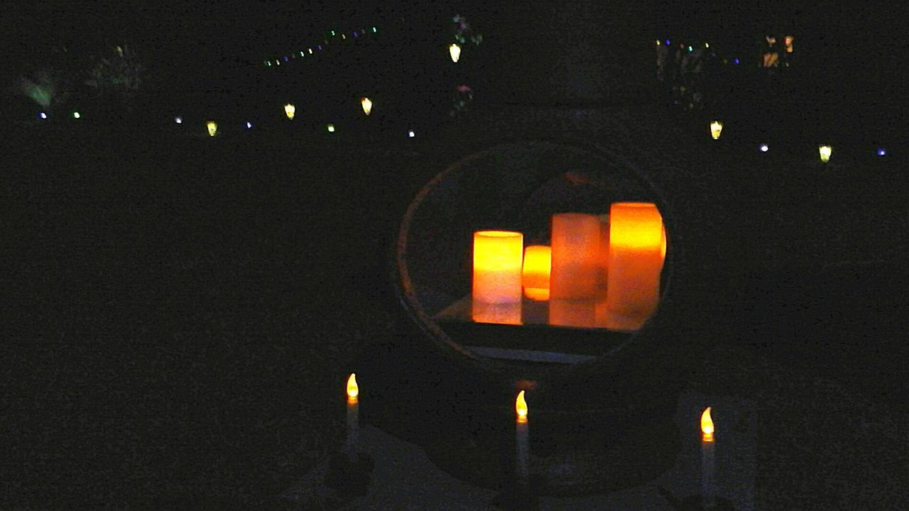 Lit candles on walkway at night