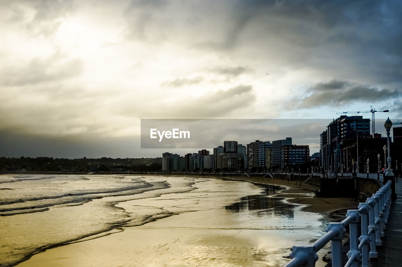 BUILDINGS BY SEA AGAINST SKY