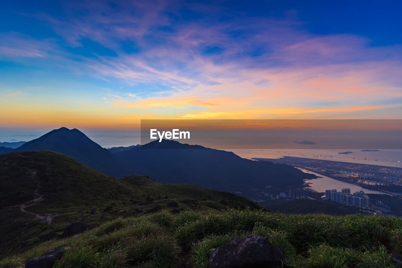 Scenic view of mountains against sky at sunset