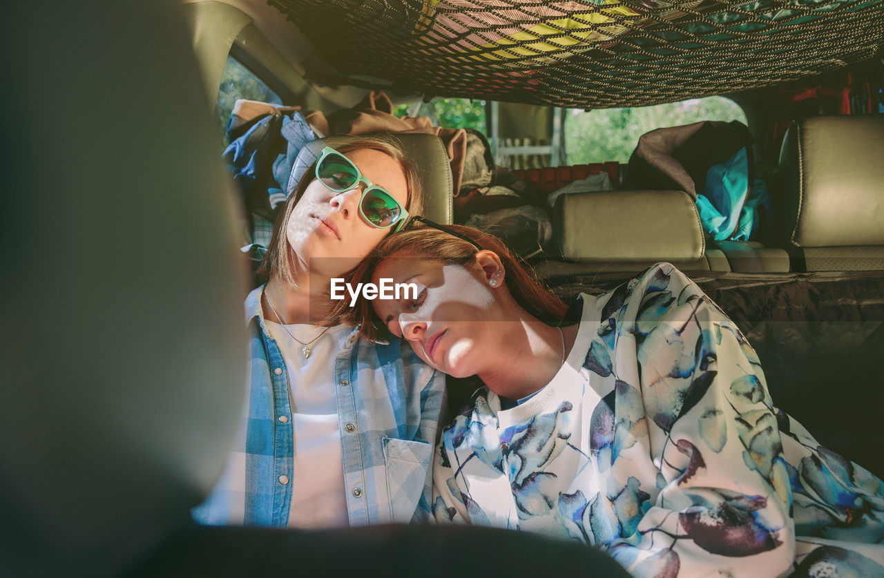 Female friends sleeping in car