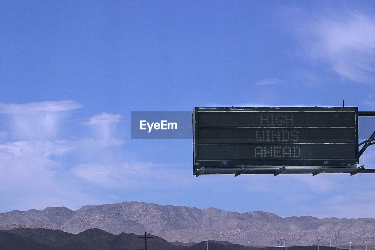 Warning sign against mountains