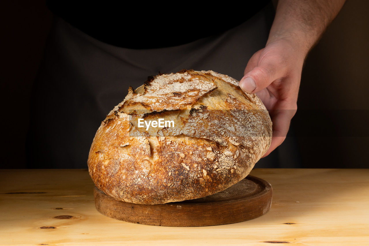 midsection of man holding bread