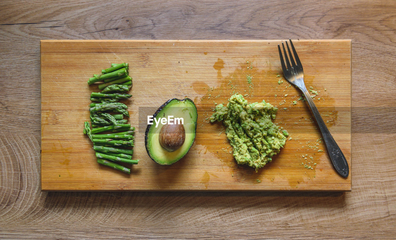 Overhead photo of avocado toast ingredients on wooden cutting board