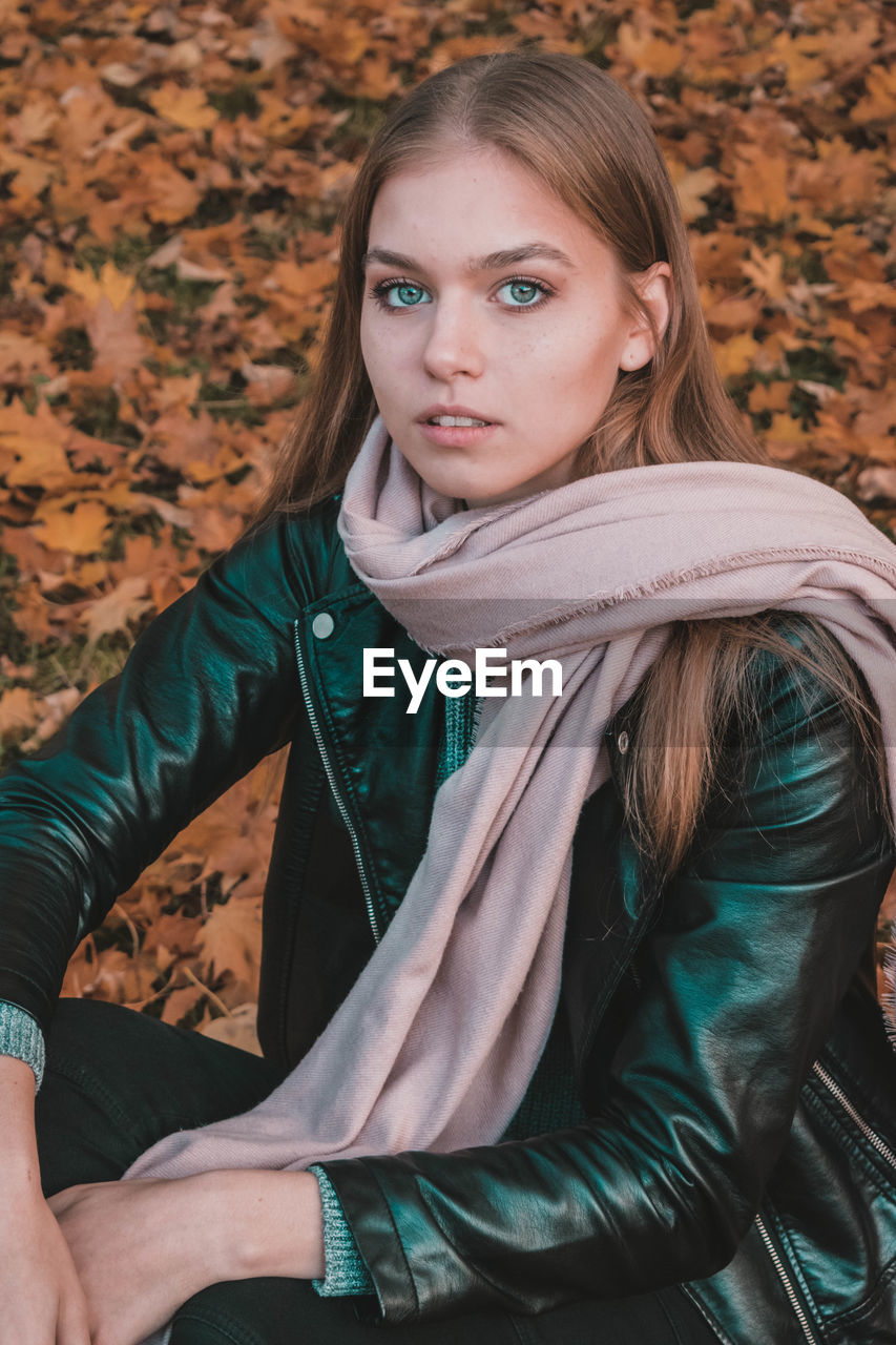 PORTRAIT OF A YOUNG WOMAN WITH AUTUMN LEAVES