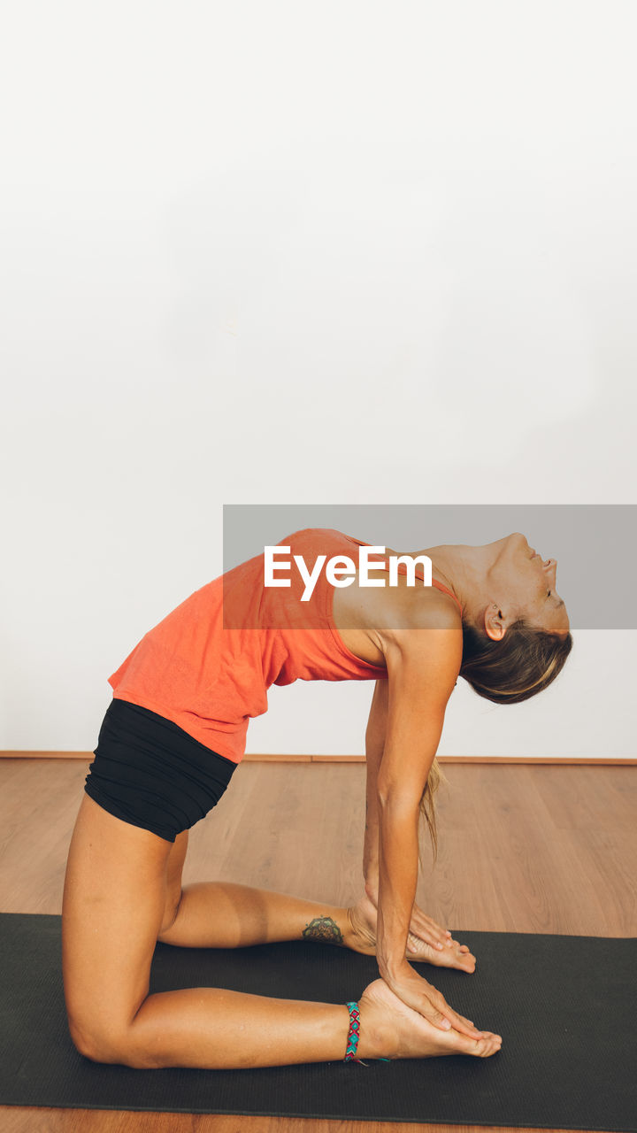 Woman doing stretching exercise at home