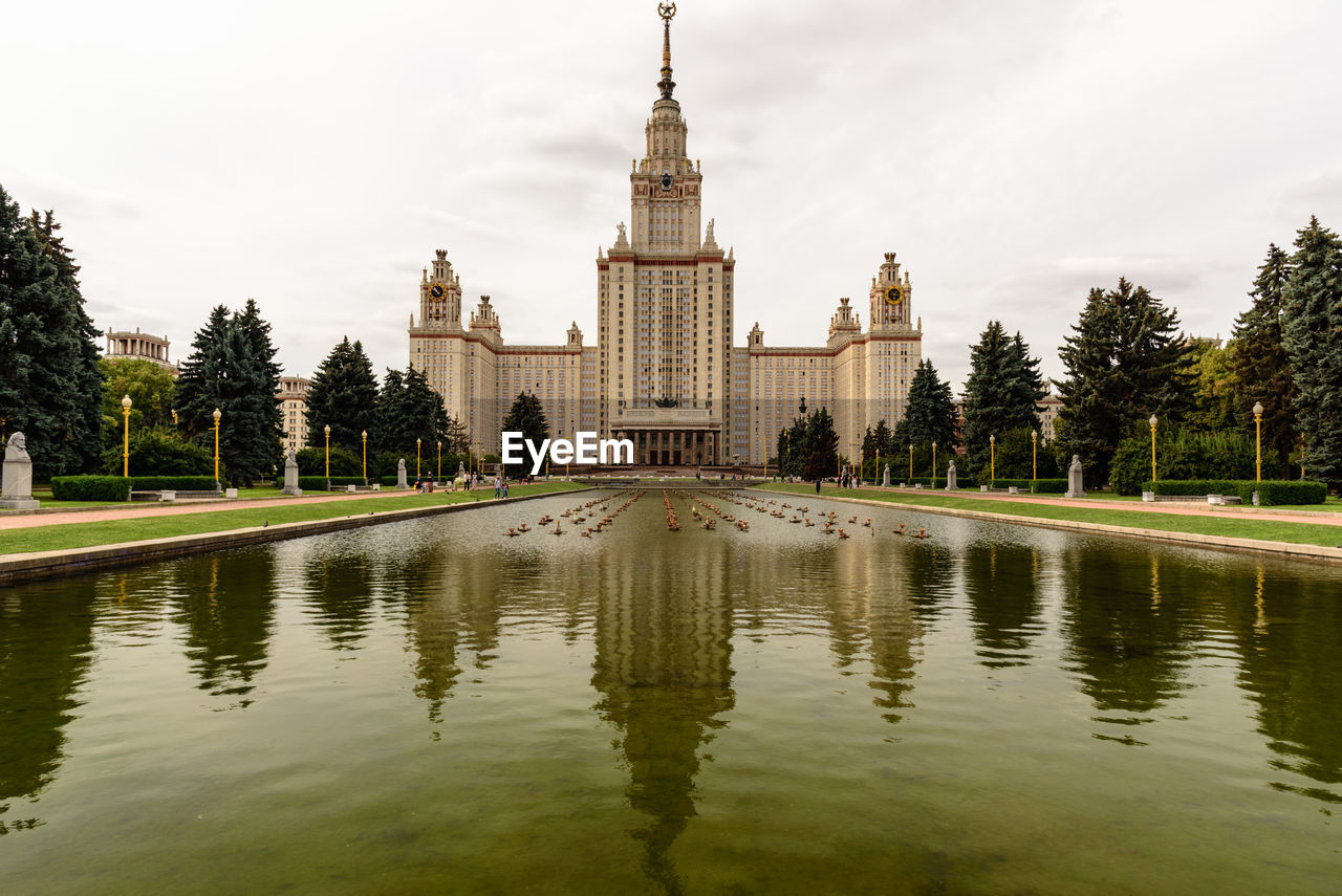 Canal in front of moscow state university against sky