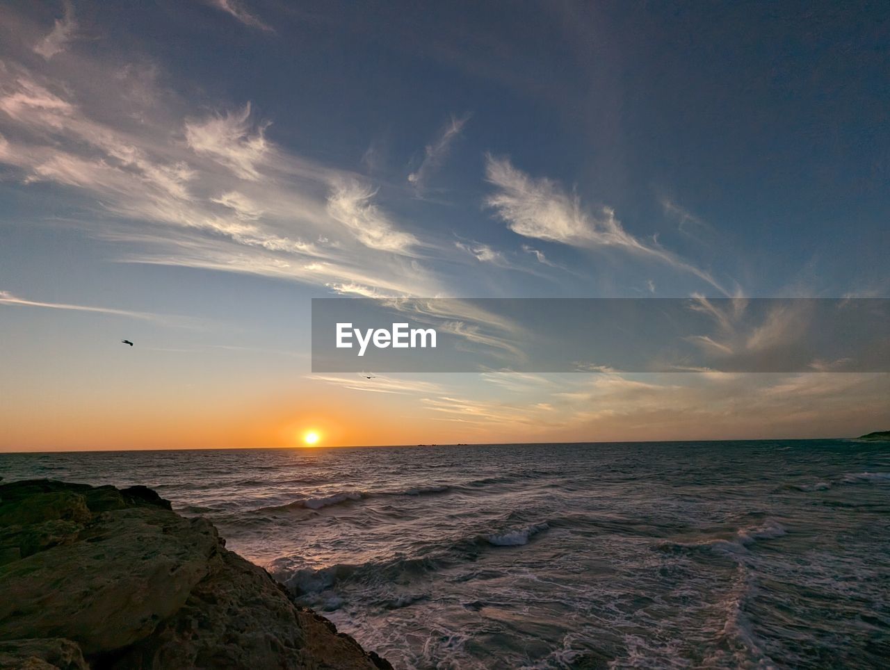sky, sea, horizon, water, sunset, ocean, beauty in nature, scenics - nature, cloud, nature, wave, land, horizon over water, dawn, beach, shore, coast, sunlight, environment, seascape, evening, sun, tranquility, no people, motion, travel destinations, outdoors, landscape, travel, rock, tranquil scene, wind wave, coastline, body of water, afterglow, dramatic sky, blue, urban skyline, idyllic