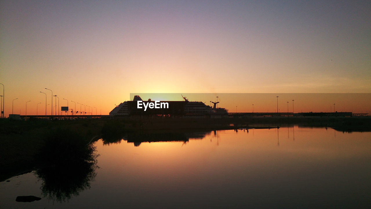 SCENIC VIEW OF LAKE AGAINST ORANGE SKY