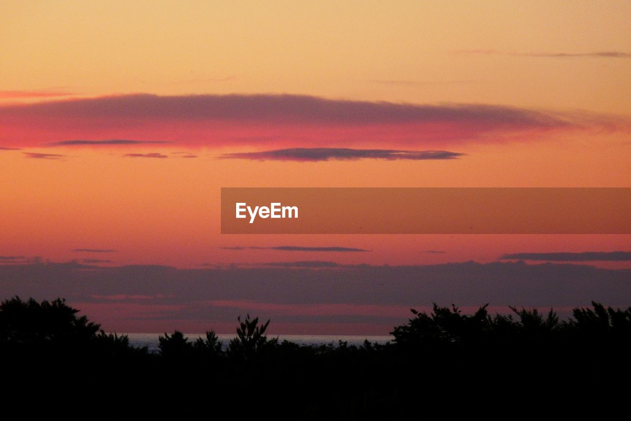 SCENIC VIEW OF DRAMATIC SKY OVER SILHOUETTE LANDSCAPE