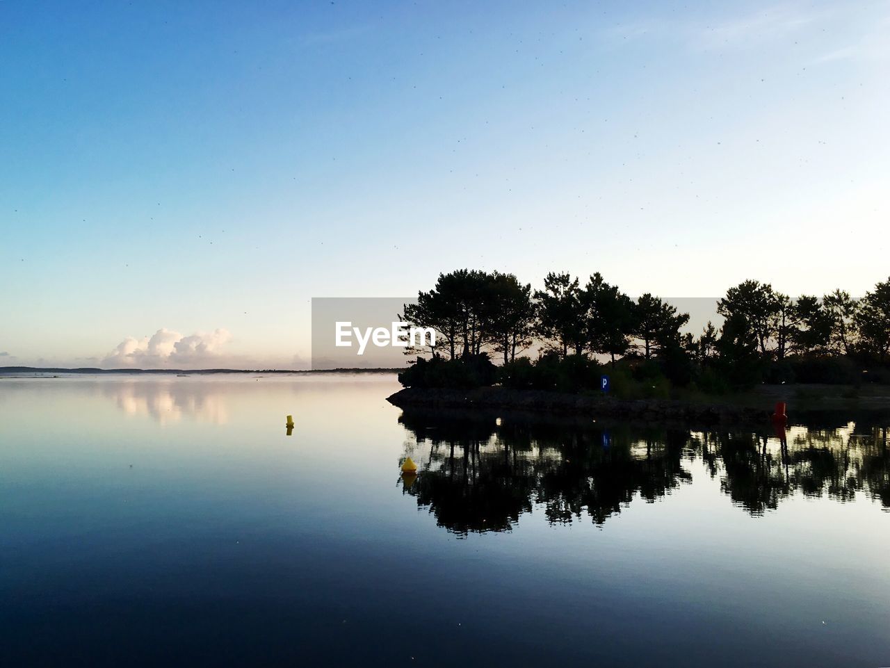 Scenic view of calm lake against sky