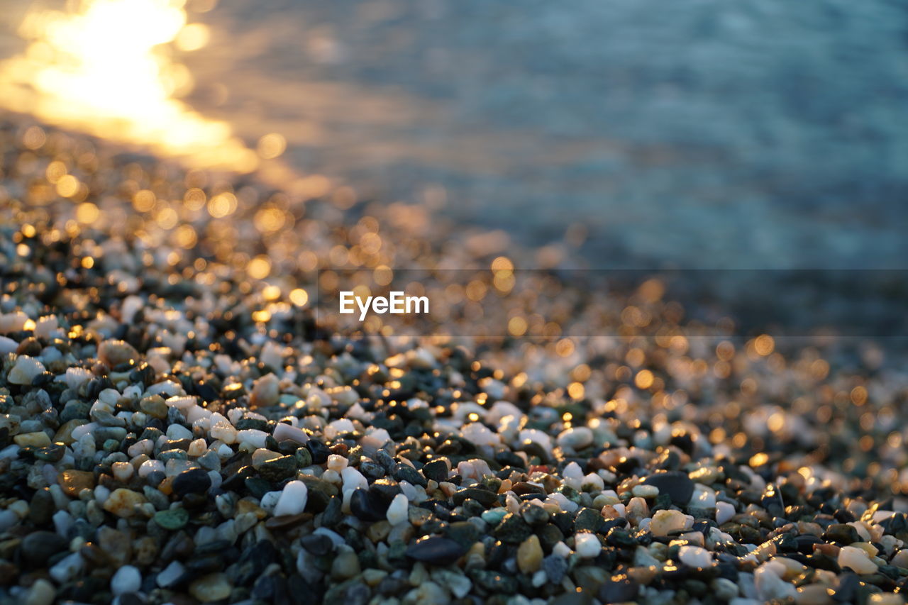 CLOSE-UP OF PEBBLES ON BEACH