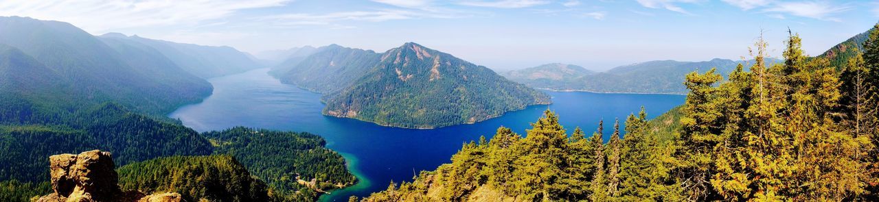 Panoramic view of trees and mountains against sky