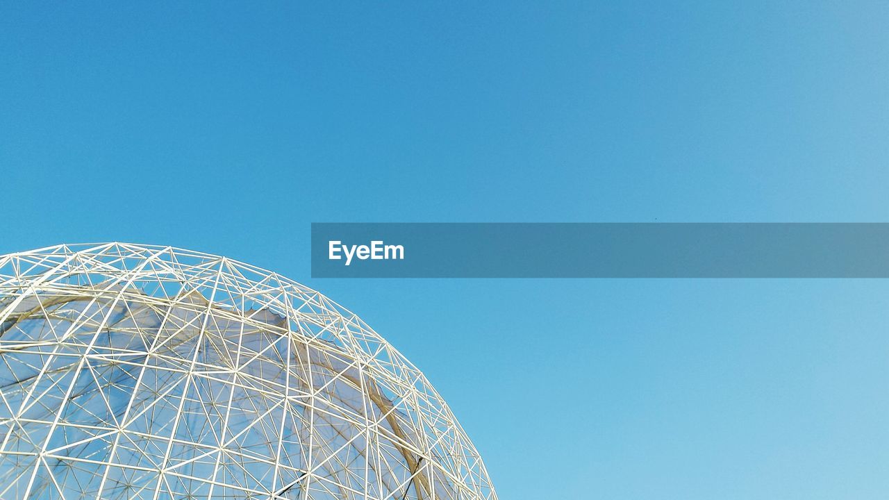 Low angle view of dome structure against clear blue sky
