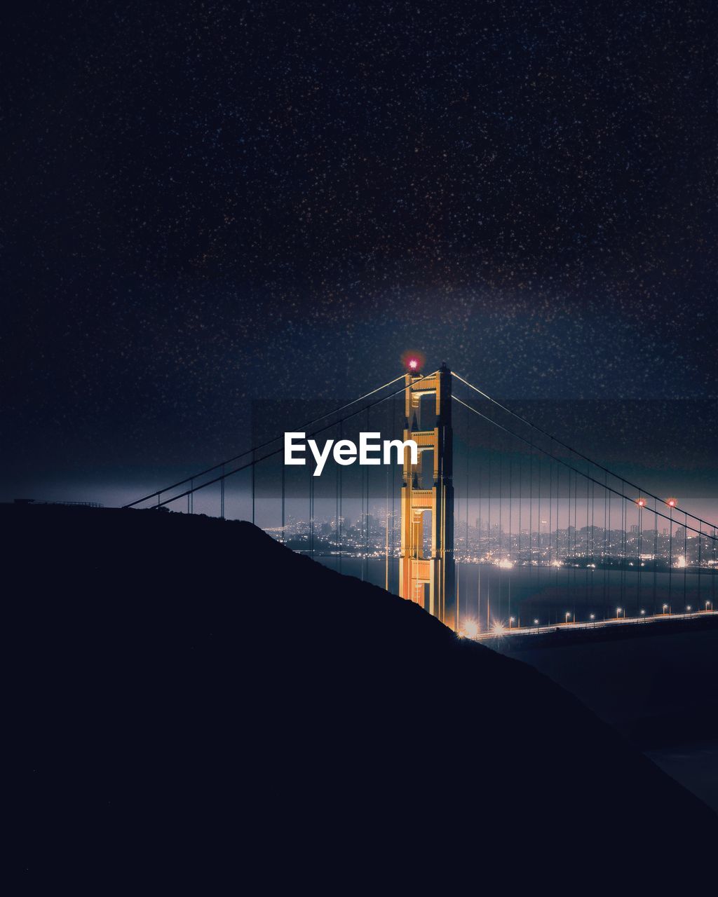 Golden gate bridge over bay against clear sky at night