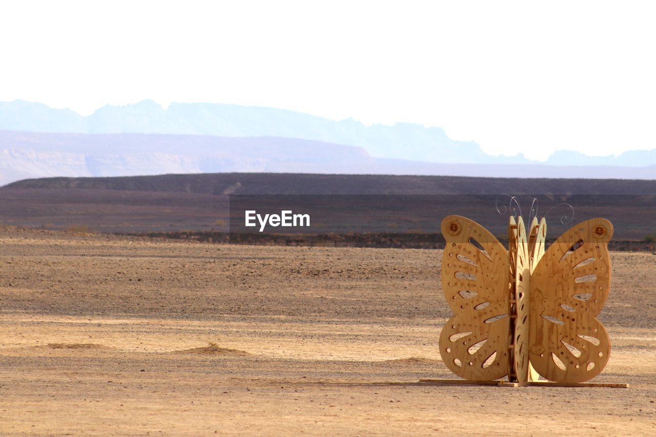 HIGH ANGLE VIEW OF SHOES ON DESERT