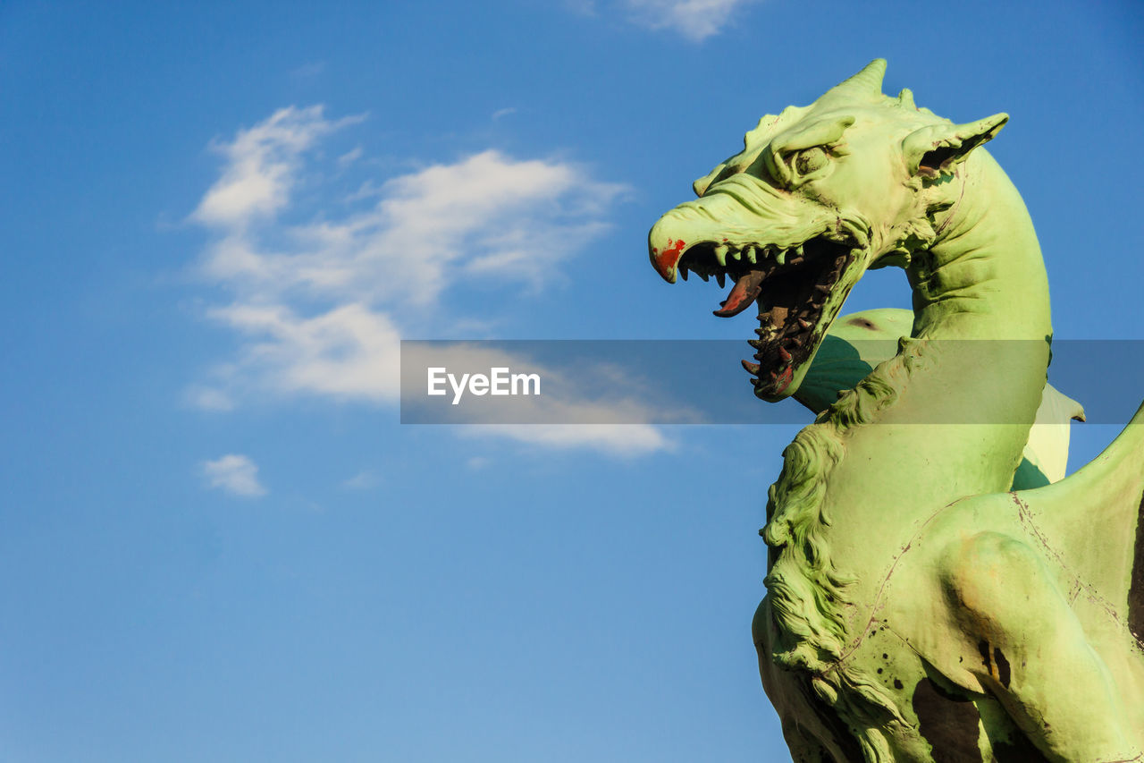 LOW ANGLE VIEW OF ANGEL STATUE AGAINST BLUE SKY